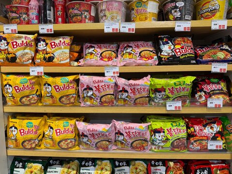 Khimki, Russia - June 25, 2026: A selection of instant noodles on a supermarket shelf featuring Buldak and Samyang brands with vibrant packaging designs