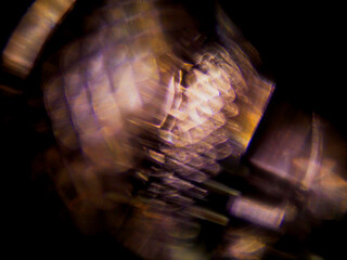 Fototapeta premium Abstract blurred image of colorful light patterns. Dark background with glowing blue and orange hues. Focus is soft, creating a dreamy, atmospheric effect. Good for design and special effects.