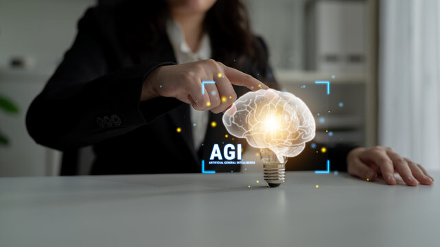 Business Professional Interacting with Conceptual Light Bulb Brain Representing Advanced Artificial General Intelligence in Modern Office Environment Haptic.