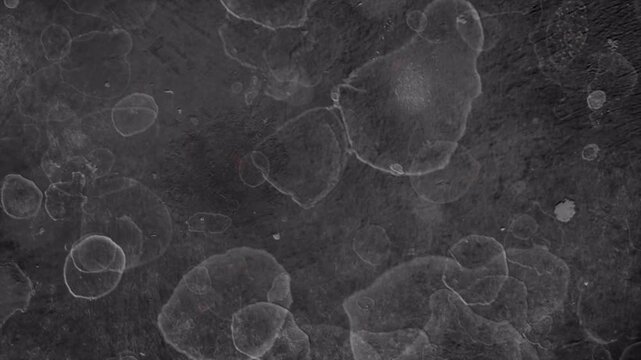Abstract dark grey grunge background with circular texture patterns.