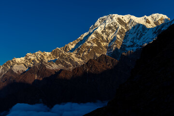 Fototapeta premium Spectacular view of the Annapurna mountain range seen from the Annapurna Base Camp trekking route in the Himalayas of Nepal. Towering snow-covered peaks rise dramatically above the surrounding glacier
