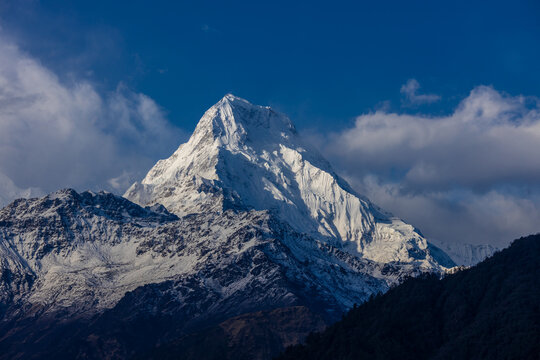 Spectacular view of the Annapurna mountain range seen from the Annapurna Base Camp trekking route in the Himalayas of Nepal. Towering snow-covered peaks rise dramatically above the surrounding glacier