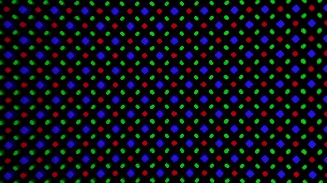 Macro video of smartphone OLED display pixels under magnification, abstract tech background. 