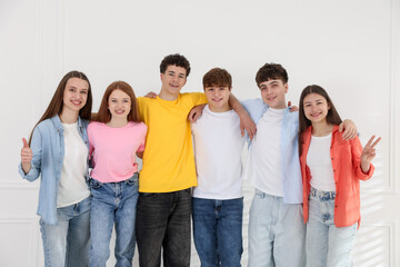 Obraz premium Portrait of happy teenagers near white wall indoors