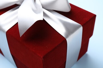 Fototapeta premium Beautiful velvet gift box on light blue background, closeup