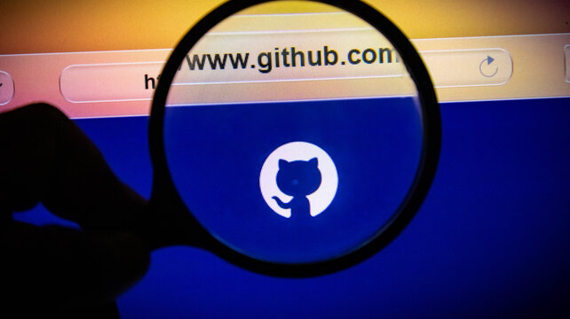 Magnifying glass over the github logo on a computer screen