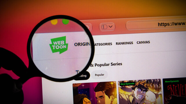 Magnifying glass held over the webtoon website on a computer screen