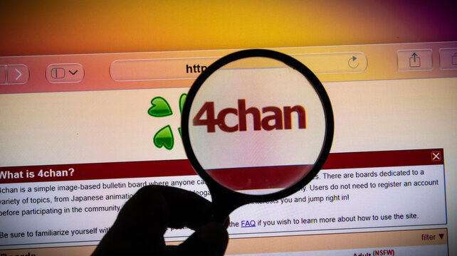 Magnifying glass over the 4chan website logo on a computer screen
