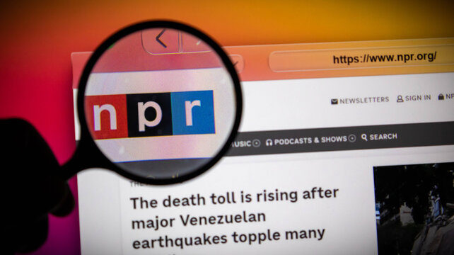 Closeup of a magnifying glass over the npr logo on a computer screen