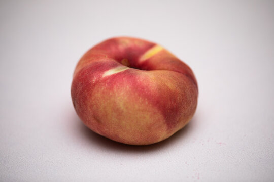 Donut Peach on light pink background closeup