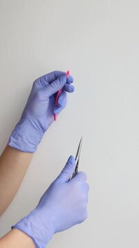 Dentist hands separating orthodontic elastic ligature rings close up macro