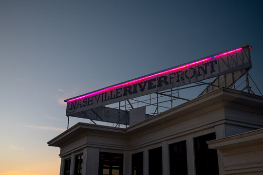 Nashville, Tennessee - June 6, 2026: Neon illuminated Nashville Waterfront sign at sunset and blue hour in Nashville, Tennessee
