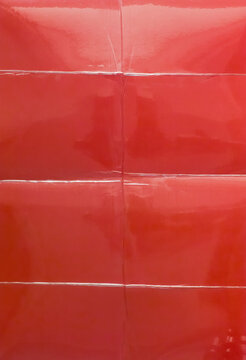 Glossy Red Photo Paper Behind Laminated Film with Fold Creases Overlay