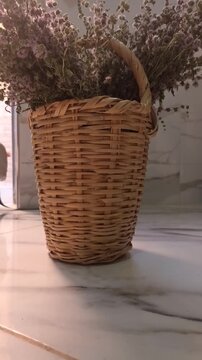 Dried Pennyroyal Herbs in Wicker Basket on Marble Table
