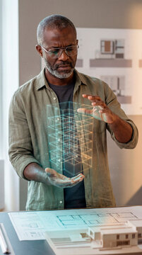 Engaged Architect Analyzing Holographic Building Model
