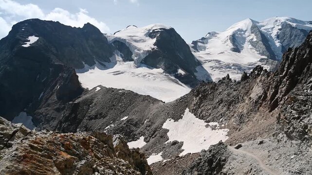 Drone View from Rocky Alpine Ridge with Snow-Covered Peaks and Glaciers, Bernina Pass, Swiss Alps