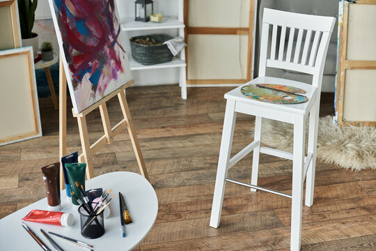 A cozy artist studio with a canvas easel, vibrant paints, and an atmosphere that sparks creativity.