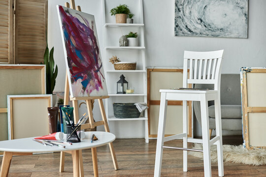 A cozy studio with a canvas easel, paints, and an atmosphere that sparks creativity.