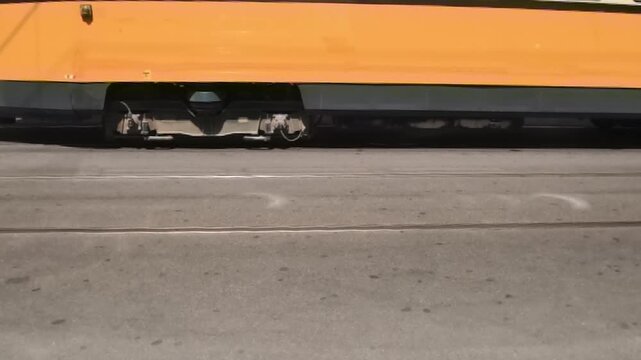 Descrizione
Horizontal 1080p 240fps ultra slow motion low angle video of tram wheels moving on steel tracks. Close up shot of city public transit carriage bogie commuting on asphalt street