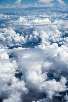 Aerial view of dense white cumulus clouds floating over the landscape in Nairobi, Nairobi County, Kenya.