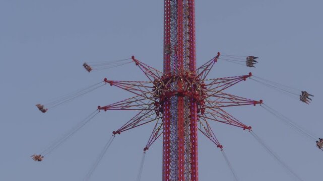 Steady View Of The Asiatique Skyflyer Rising Upward With Riders Suspended Above The Chao Phraya River Waterfront In Bangkok, Thailand