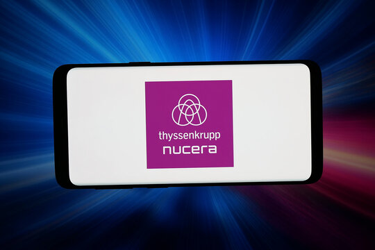 Stuttgart, Germany - 06-17-2026: In this photo illustration, the logo of German engineering company Thyssenkrupp Nucera is displayed on a smartphone in front of abstract background on computer screen.