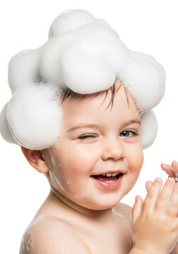 young caucasian toddler bare-chested, winking and smiling with abundant sculptural soap foam and iridescent bubbles covering head, isolated on transparent studio background, concept for baby hygiene