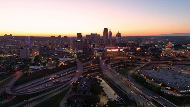 Cincinnati downtown cityscape with highway traffic at colorful sunset