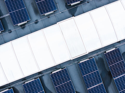Aerial view of solar panels installed on the roof of a cheese factory in Ikskile, Ogre Municipality, Latvia.