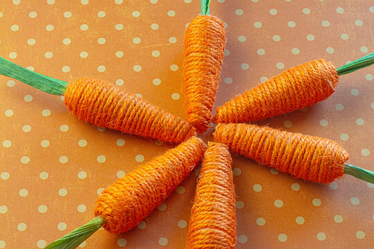 Yarn Woven Orange Carrots on an Orange Spotted Background