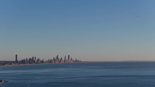 Lateral aerial view moving from left to right overlooking the Surfers Paradise skyline from Burleigh Headland on the Gold Coast, Queensland, Australia