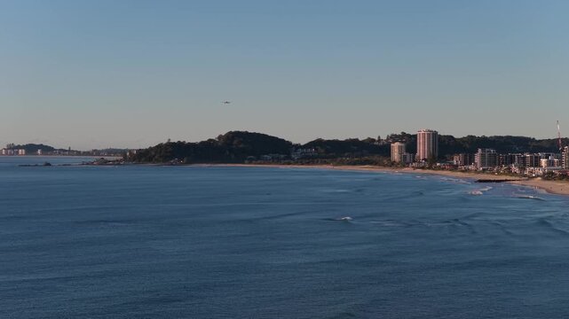 Forward aerial view approaching the Burleigh Headland coastline and beachfront on the Gold Coast, Queensland, Australia