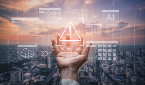 A hand holds a glowing warning symbol against a scenic sunset over a city, representing technology, alerts, and information in modern urban life. Gantry