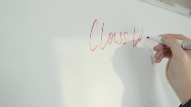 Hand writing class work with red marker on clean white board