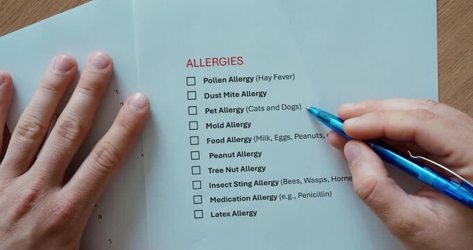 Close-up of a person filling out an allergy questionnaire on a medical form. Healthcare, patient information, medical history, diagnosis, and allergy screening concept.