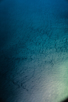 Aerial view of the deep blue water surface with subtle ripples and light reflections in Nairobi, Nairobi County, Kenya.