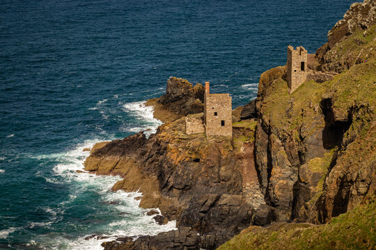 Panoramic coastal landscape of Cornwall featuring the historic ruins of Botallack Mine engine houses on steep cliffs