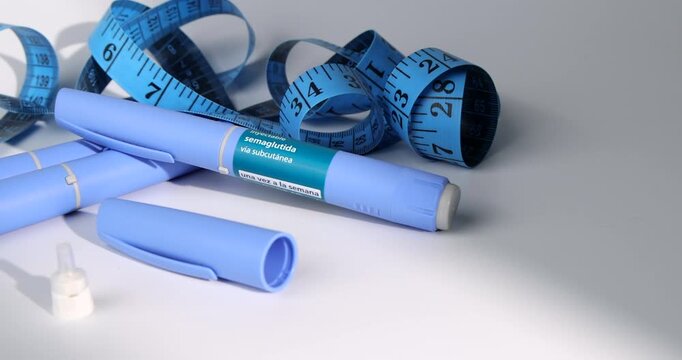 Horizontal tracking view of blue semaglutide injection pens for obesity reduction programs and diabetes on white background layout