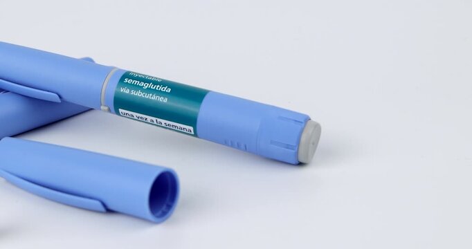 Horizontal tracking camera view of blue semaglutide glp1 injection pens for subcutaneous diabetes care on white background area