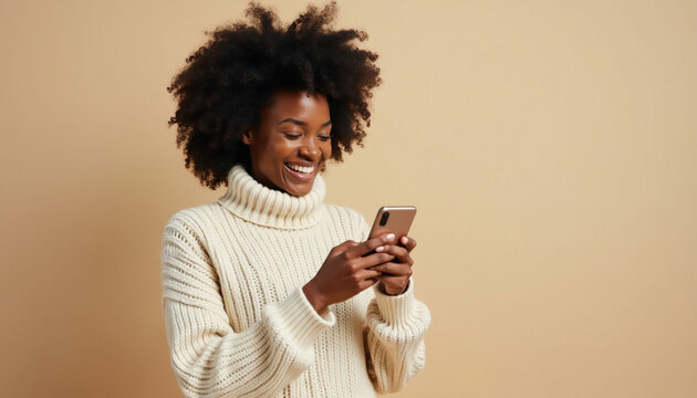 Smiling woman with curly hair enjoys funny content on her phone. Person reacts happily while browsing social media on mobile device. Female feels joy watching something amusing online.