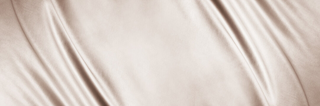 Light brown beige textile fabric. Elegant luxury background. Soft folds, curved lines. Nude pastel. Beauty branding fashion wedding. Premium cosmetic design. Empty template. Flat lay, table top view.