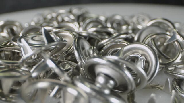 Metal eyelets lie on a rotating surface