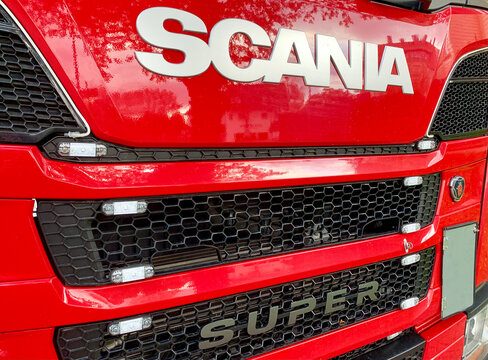 Braunlage, Germany, 15 May 2026: Close up of Scania Super heavy-duty commercial cargo vehicle cabin front panel in vibrant red color