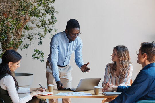 Diverse business team collaborating and brainstorming during a corporate meeting