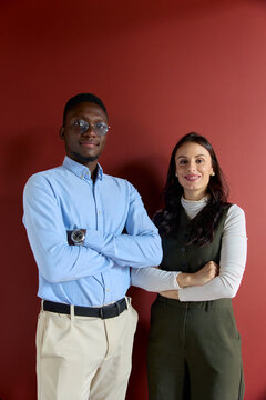 Diverse business partners standing together, confident and smiling, collaborating on a new project, representing professionalism and teamwork in a modern office