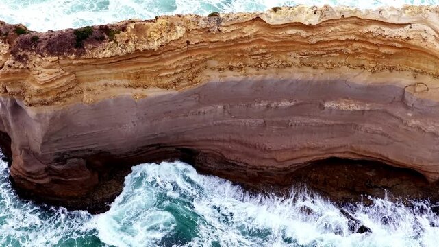 Aerial vertirama over Twelve Apostles and stormy ocean waves in Victoria of Australia.