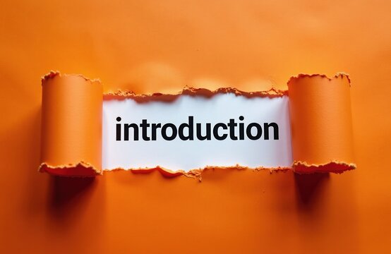 Text word introduction reveals through torn orange paper. Concept of new beginnings, starting point, first step, fresh chapter, or beginning of something.