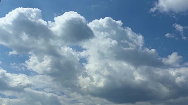 Amazing timelapse of Cumulus clouds forming in the blue sky, white giant fluffy clouds moving in summer day, 4K