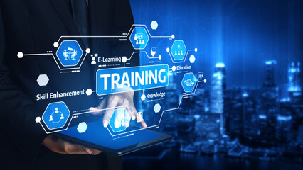 Obraz premium A businessman interacts with a tablet displaying training icons, representing the future of e-learning and skill enhancement in a modern cityscape. Tessel