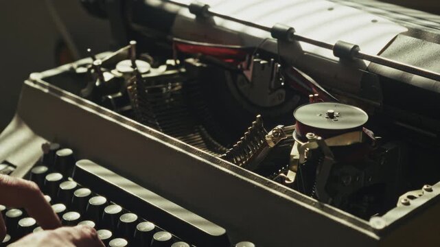 Retro typewriter keys strike the ribbon as a writer works through ideas before crumpling and discarding the page. Captures creativity, frustration, editing, and the writing process.